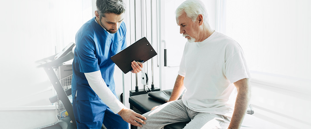 Therapist examining a resident's knee